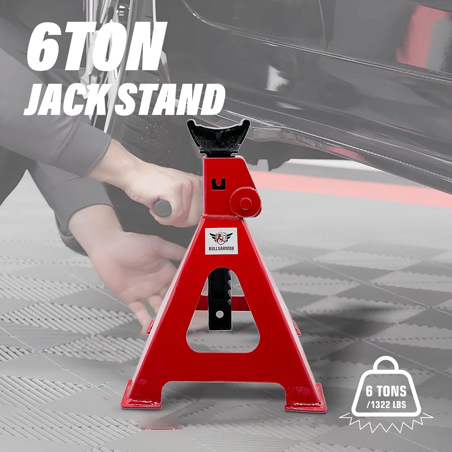 Red 6-ton jack stand with a person using it on a car, on a gray floor.