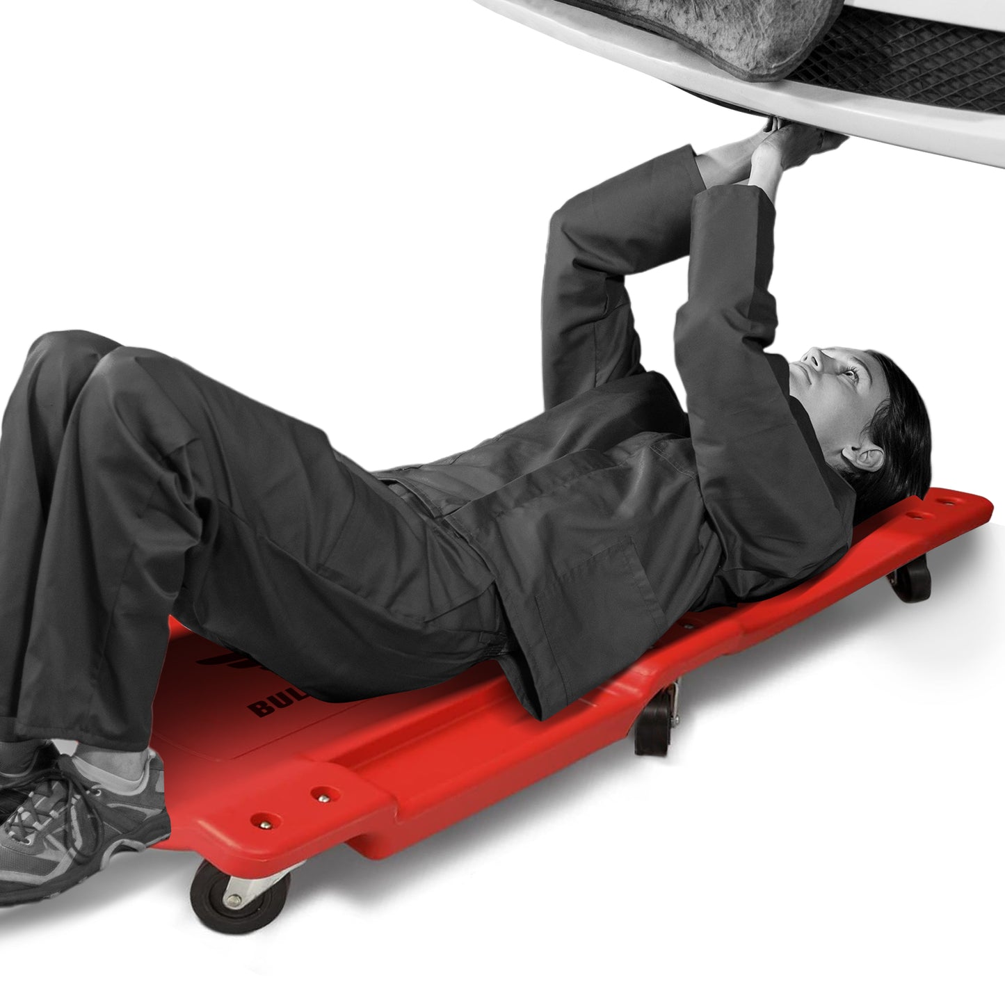 Person using a red car jack stand on a white background